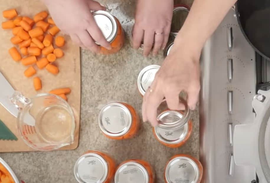 tightening lids on jars and then place in pressure canner